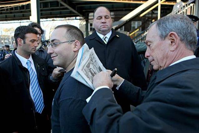 Mayor Bloomberg autographs a copy of the Daily News, AP Photo by David Goldman